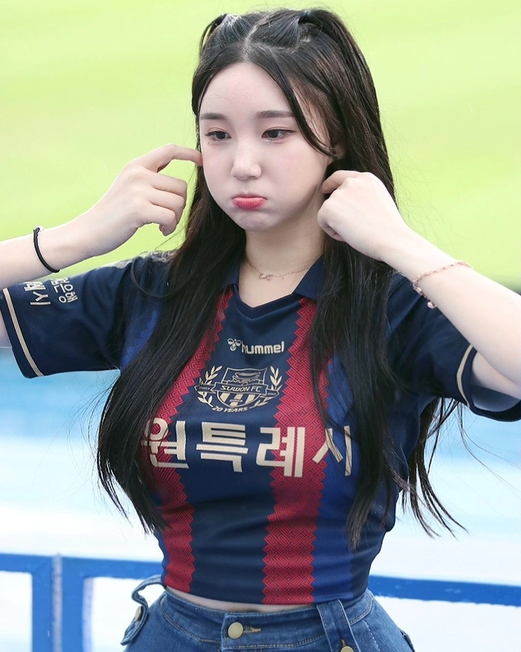 A collection of photos of Kim Hyun Young, a cheerleader model born in 2000, wearing Suwon FC uniforms