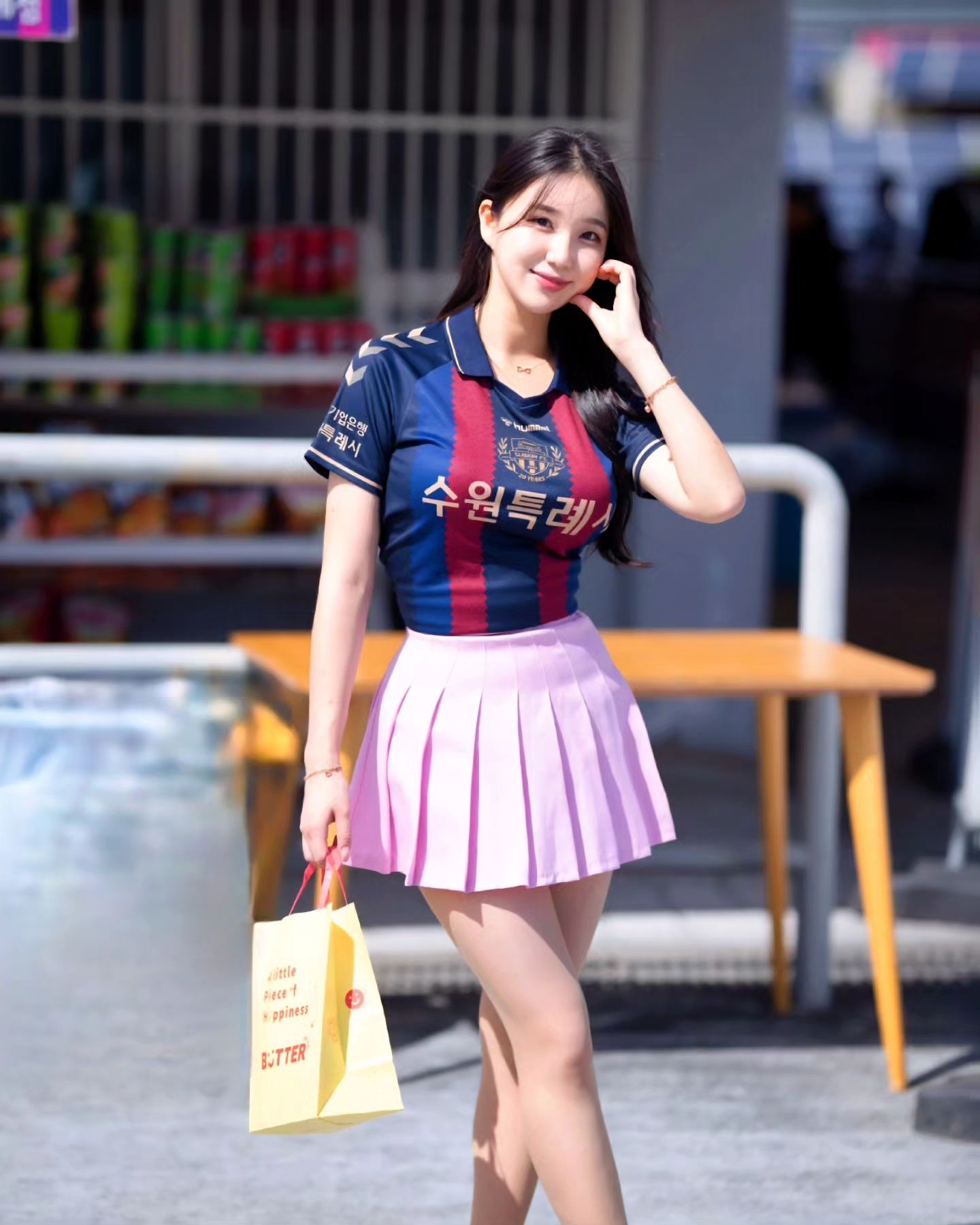 A collection of photos of Kim Hyun Young, a cheerleader model born in 2000, wearing Suwon FC uniforms