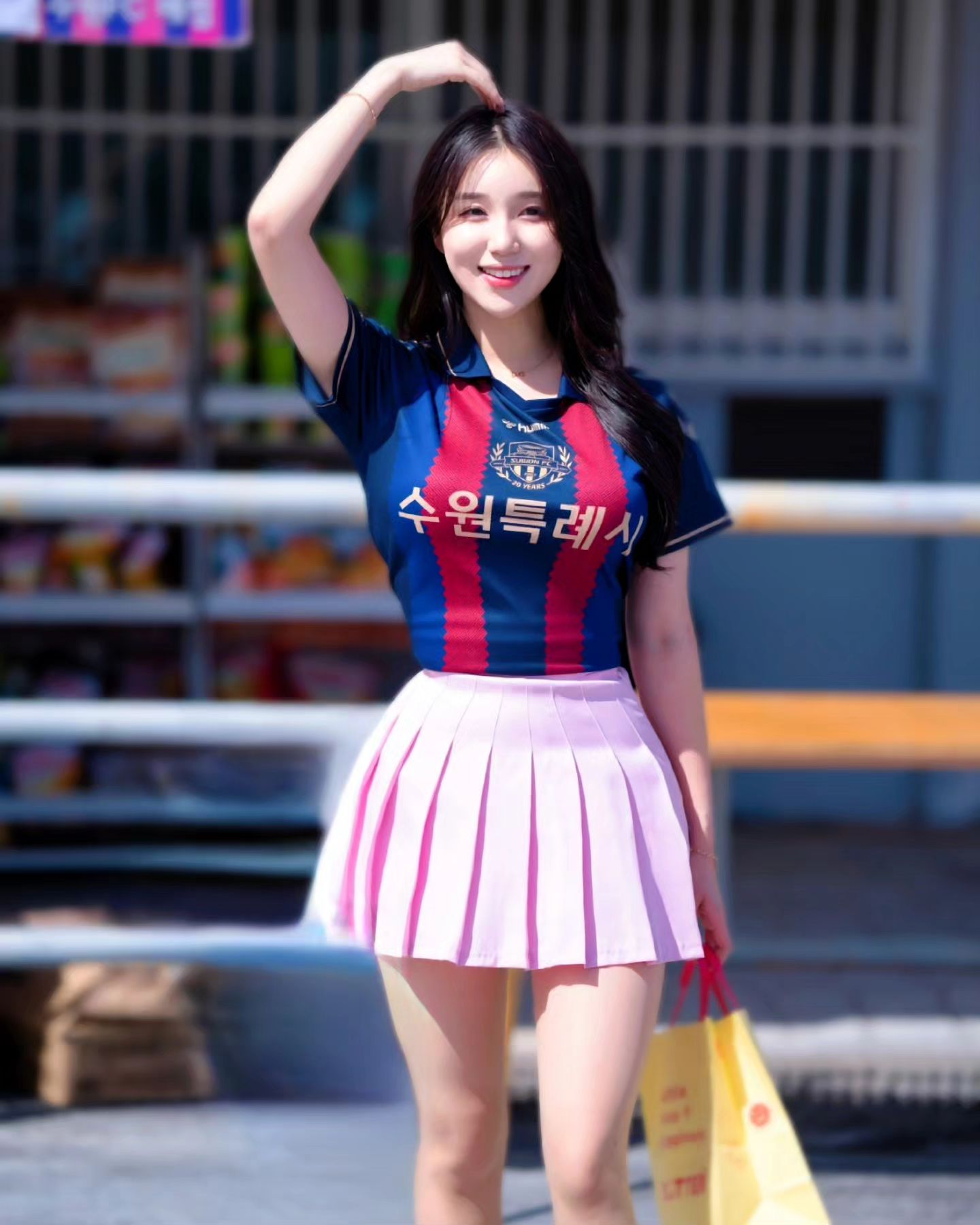 A collection of photos of Kim Hyun Young, a cheerleader model born in 2000, wearing Suwon FC uniforms