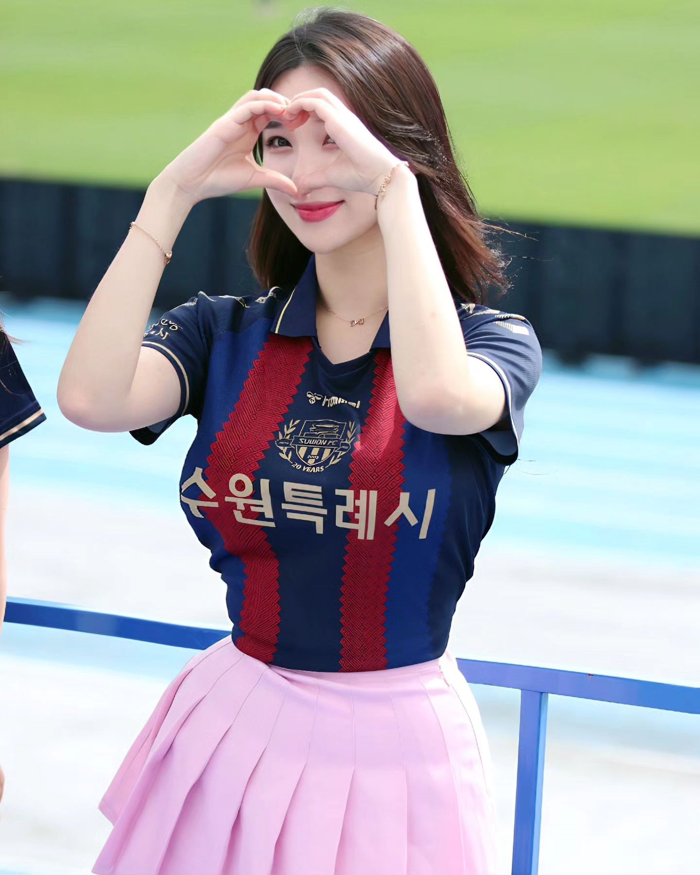 A collection of photos of Kim Hyun Young, a cheerleader model born in 2000, wearing Suwon FC uniforms